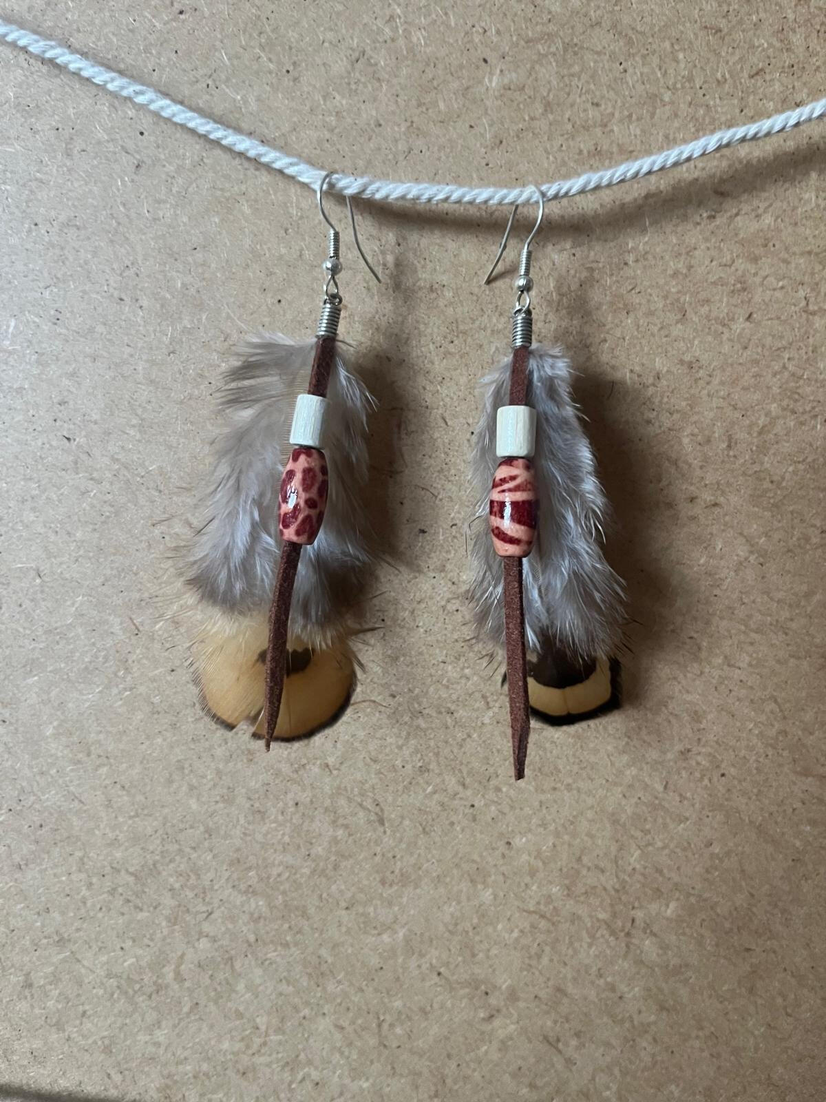 Pendientes artesanales Senda Terracota con plumas suaves, cuentas en tonos terracota y elementos naturales